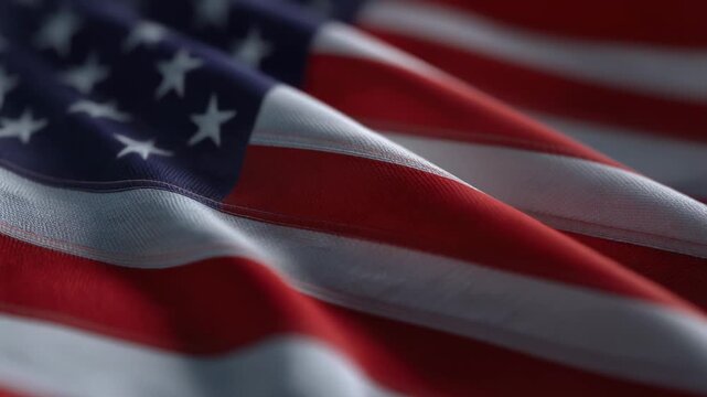 Close up of American flag fabric with stars and stripes waving in the wind patriotic background