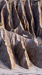 earth palette with sandstone beige, driftwood tan, and muted clay arranged as vertical