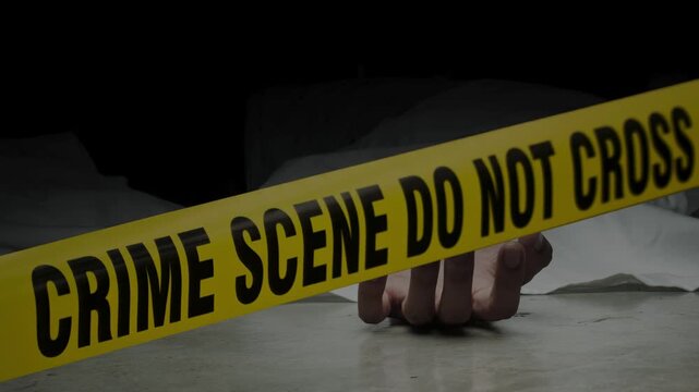 Crime scene do not cross police tape. Police Line Tape with dead body of murder victim lying on floor at crime scene.