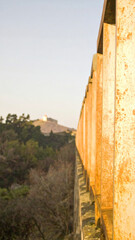 warm dusk palette with golden bronze, muted apricot, and hazy sunset rose formed as vertical