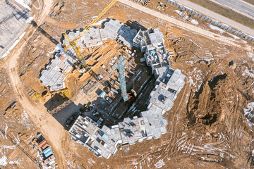 aerial top view of construction site with multistory apartment building under construction.