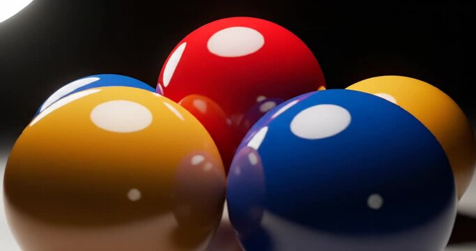 Colorful glossy balls arranged artfully on a smooth surface with soft lighting creating shadows