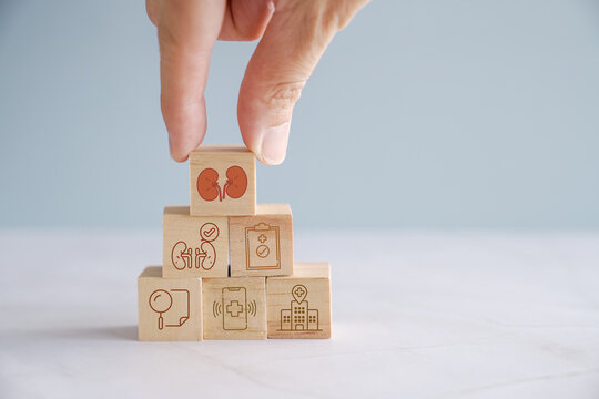 Hands holding wooden blocks with health icons,  urology, kidney, world kidney day, organ donation, health insurance concept