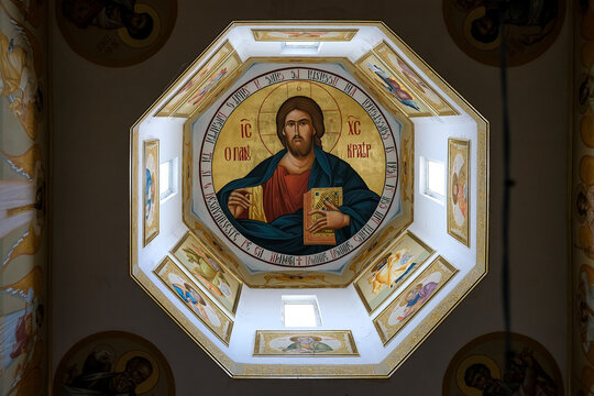 Bucharest, Romania &ndash; Interior dome of the Church of Saint John Chrysostom, featuring a traditional Orthodox Christ Pantocrator surrounded by saints and golden iconography.