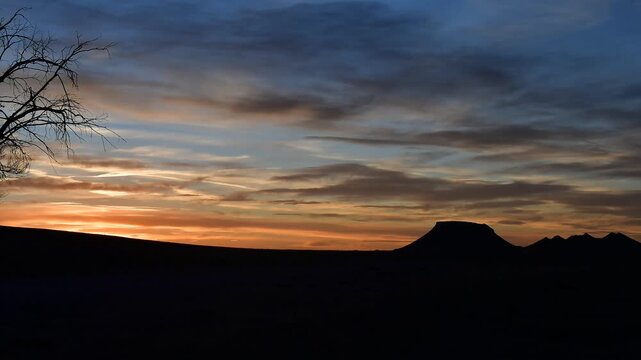 With a silhouette of hills off into the distance, this sunset has the clouds change colors quickly. Time-lapse video has all the motion moving about five times faster than normal.