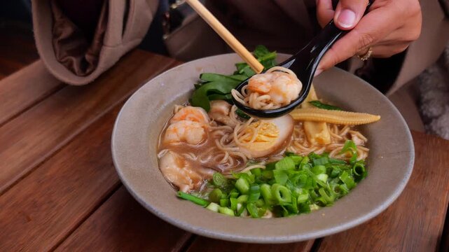 Enjoying shrimp noodles in a cozy restaurant