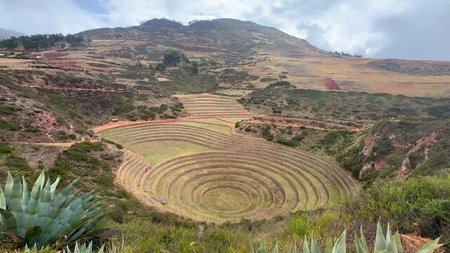Moray circular terraces Zona arquelogica Moray Peru Per&uacute; Sacred Valley Salineras de Maras rainy season sunny cloudy Peruvian Andes Mount Patacancha Chic&oacute;n Ancopacha Ollantaytambo Cusco region pan left
