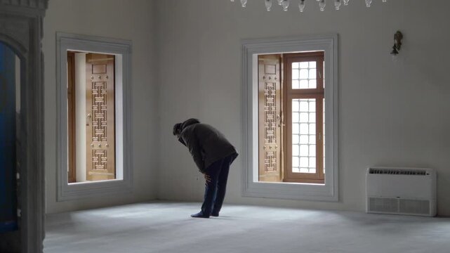 Man Performing Islamic Prayer in a Peaceful Empty Room