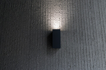 A black light fixture is mounted on a wall