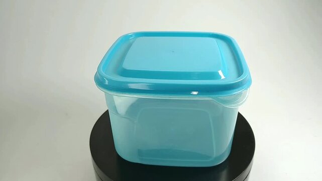 Blue plastic storage box rotating isolated