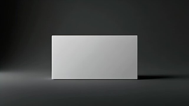 Minimalist white rectangular box mockup on matte black background with soft rim lighting. Sleek product packshot.