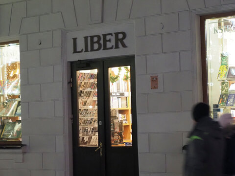 Blurred evening shot of Liber bookstore entrance on a snowy Warsaw street