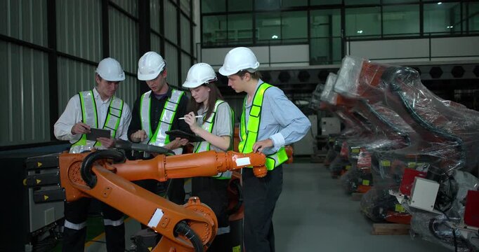 Engineering supervisor mentors trainee in robotics environment, emphasizing the importance of leadership, communication, and continuous education in managing complex machinery and technical processes
