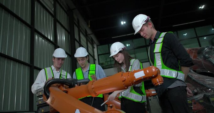 Engineering supervisor mentors trainee in robotics environment, emphasizing the importance of leadership, communication, and continuous education in managing complex machinery and technical processes

