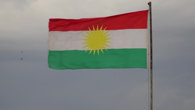 The Iraqi Kurdistan flag flutters in the wind.