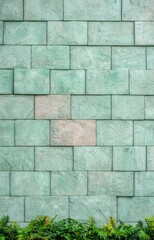 Green Stone Wall with Single Light Gray Brick