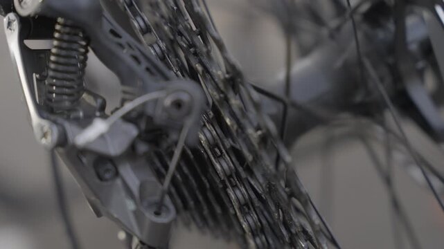 Slow motion closeup of bicycle drivetrain as cyclist rides in park Portugal