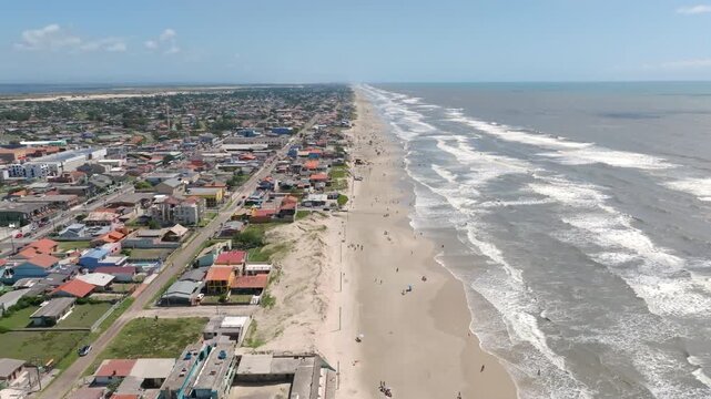Drone forward flight along Balneario Pinhal beach coastline and city in Brazil. Captured in D-Log with 10-bit color using a Hasselblad sensor.