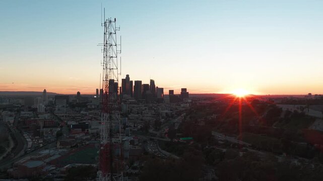 Aerial close-up dolly shot of a transmission tower in Elysian Park during sunset in Los Angeles, California. 4K