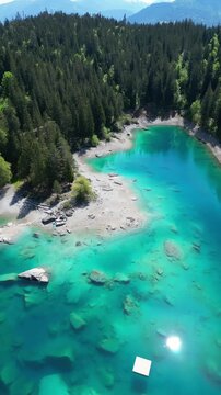Swiss Caumasee Lake Cauma Switzerland alpine nature landscape aerial, vertical video