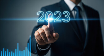 Obraz premium Businessman Pointing at Year 2023 Glowing Corporate Business Plan Future Forecast Innovation Technology Growth Development Concept