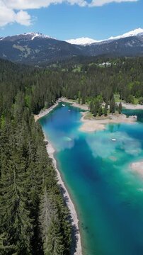 Lake Cauma turquoise water color Swiss Switzerland alpine scenery, aerial vertical video
