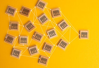 Business sale growth and expand shop franchise concept, Store illustration print screen on wooden cube block connection link with others shop and supermarket.