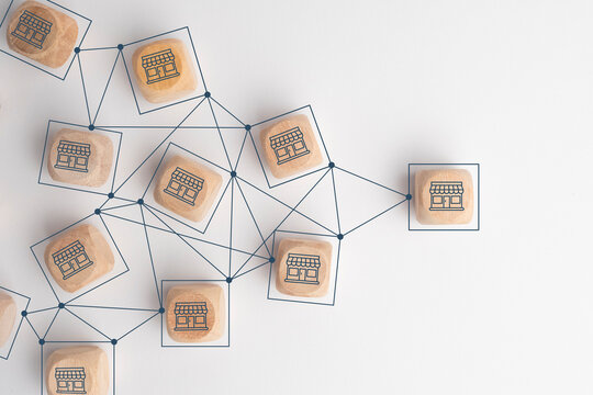 Business sale growth and expand shop franchise concept, Store illustration print screen on wooden cube block connection link with others shop and supermarket.
