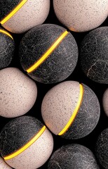 Close-Up of Black and Gray Textured Balls with Yellow Stripes
