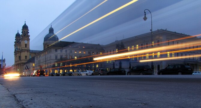 Long exposure view of Odeonsplatz in Munich with light trails along Ludwigstra&szlig;e. Baroque Theatinerkirche with yellow facade and domes dominates this historic city landmark, DE, 17 Feb. 2011