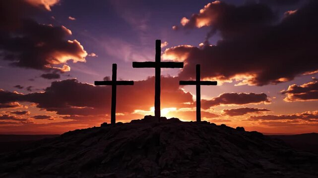Three crosses on a hill silhouetted against a dramatic sunrise. The crucifixion of Jesus Christ at Calvary. A symbol of christianity, faith, and easter