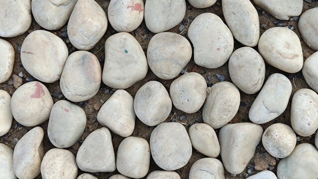 Texture of large smooth stones decoratively laid out on the ground