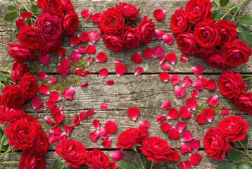 top view Vibrant red roses and scattered petals on a textured surface