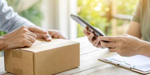 Business concepts and mobile payments for parcel delivery represent cashless transactions in the e-commerce delivery business.