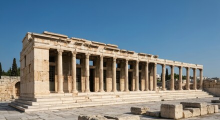 Obraz premium Ancient, columned building under a clear blue sky, showing architectural detail