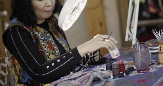 Artist Painting Handmade Doll in Craft Workshop