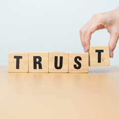 Obraz premium wooden block TRUST. Trustworthy, Truth, beliefs business and agreement concept