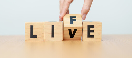 Naklejka premium hand change wooden block Live to Life. Lifestyle, Live your life, learning, motivation and mindset concepts