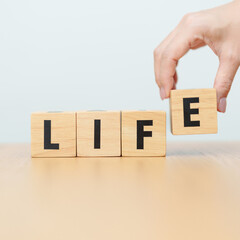 Naklejka premium hand change wooden block Live to Life. Lifestyle, Live your life, learning, motivation and mindset concepts