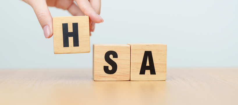 hand change wooden block from FSA. HSA, Flexible Spending Account and Health Savings Account, Medical Expenses, Tax Benefits and healthcare concepts