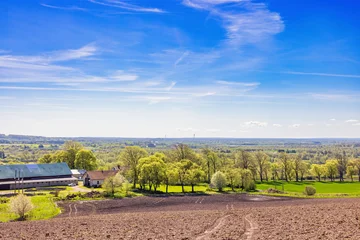 Fotobehang Pantone 2025 Mocha Mousse Rural landscape view with a farm in the countryside a sunny spring day  © Lars Johansson