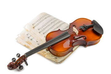 Obraz premium Still life with a violin and music book on a white background