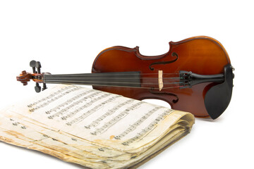 Fototapeta premium Still life with a violin and music book on a white background