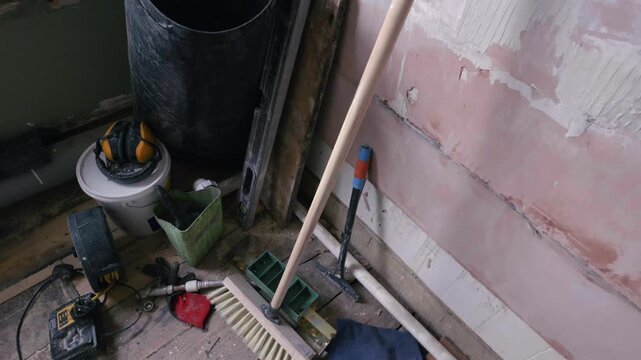 Bathroom renovation; orbit shot looking down on DIY tools in stripped back room during daytime.