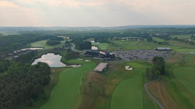 Rising Pullback Aerial Shot Of The TPC Toronto At Osprey Valley Golf Course Clubhouse During Sunrise.