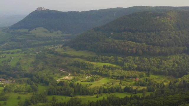 An panoramic aerial View beside the village Neuffen and castle Burg Hohenneuffen in Germany  on an early morning with clouds in spring.