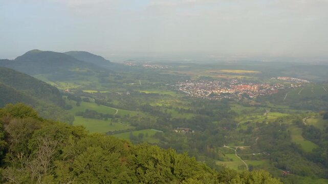 An panoramic aerial View beside the village Neuffen and castle Burg Hohenneuffen in Germany  on an early morning with clouds in spring.