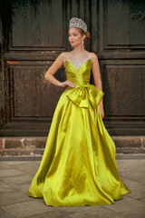 Fototapeta premium blonde girl with blue eyes and a long green dress