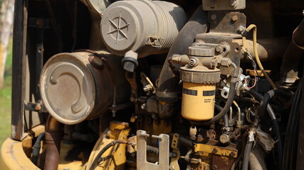 Old yellow fuel filter. Pre fuel filter or water separator for tractor or excavator with line in excavator fuel feed system with focus selection. © kanin