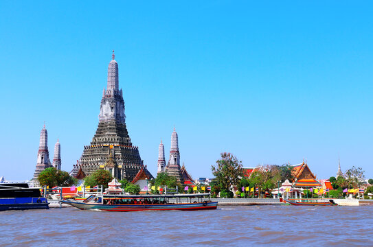 Buddhist Temple of Dawn Wat Arun, sightseeing landmark of Bangkok, Thailand. Famous tourist attraction boat ride on Chao Phraya river. Summer vacation, relaxing, topic of travel, trip, cruises, tour